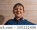 Portrait of a boy 8 years old brunette in a blue shirt. Smiling with closed lips. 105222496