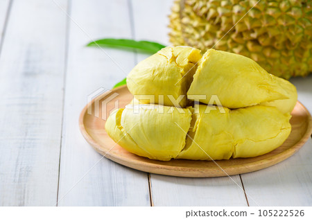 Durian fruit. Ripe monthong durian on wood plate and white wood background, king of fruit from Thailand Durian fruit. Ripe monthong durian on wood plate and white wood background, king of fruit from Thailand 105222526