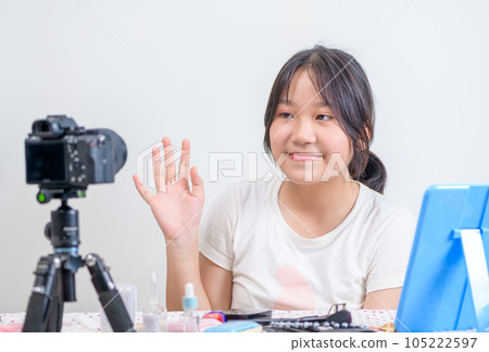 Beauty girl blogger concept, Asian girl look at camera and  waved hello in live streaming. 105222597
