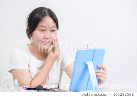Cute asian girl uses cotton pad with toner for cleaning make up feeling so fresh and clean with healthy skin, 105222598