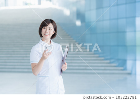 Young female nurse calling by smartphone 105222781