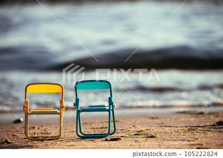 Two chairs by the sea. The concept of outdoor recreation. Beach chairs provide an opportunity to enjoy solitude with nature, surrounded by the beauty of the sea coast. Two chairs by the sea. The concept of outdoor recreation. Beach chairs provide an opportunity to enjoy solitude with nature, surrounded by the beauty of the sea coast. 105222824