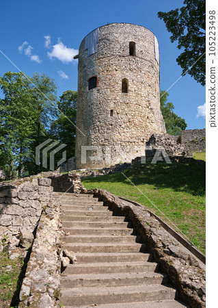 Latvian tourist landmark attraction - tower and ruins of the Cesis medieval Livonian castle in Cesis town, Latvia. Latvian tourist landmark attraction - tower and ruins of the Cesis medieval Livonian castle in Cesis town, Latvia. 105223498