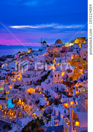 Oia village, windmills, Santorini island, Greece at colorful sunset 105224864