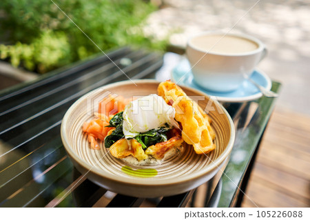 Potato waffles, Poached egg, avocado cream with salmon and egg . Healthy breakfast, protein. Restaurant dish.  105226088