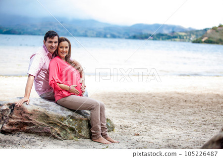 Young couple waiting for their baby at the beautiful white beach of Lake Tota located in the department of Boyaca at 3,015 meters above sea level in Colombia Young couple waiting for their baby at the beautiful white beach of Lake Tota located in the department of Boyaca at 3,015 meters above sea level in Colombia 105226487