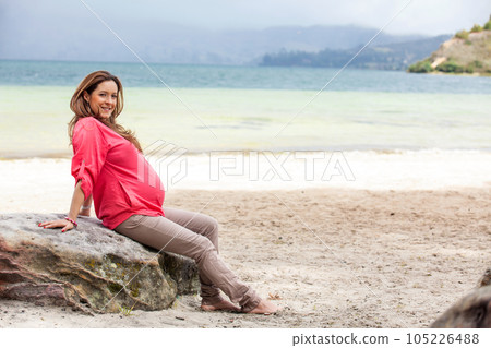Portrait of a young woman waiting for her baby at the beautiful white beach of Lake Tota located in the department of Boyaca at 3,015 meters above sea level in Colombia Portrait of a young woman waiting for her baby at the beautiful white beach of Lake Tota located in the department of Boyaca at 3,015 meters above sea level in Colombia 105226488