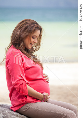 Portrait of a young woman waiting for her baby at the beautiful white beach of Lake Tota located in the department of Boyaca at 3,015 meters above sea level in Colombia 105226489