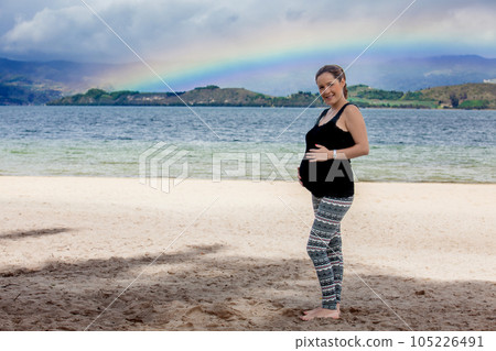 Portrait of a young woman waiting for her baby at the beautiful white beach of Lake Tota located in the department of Boyaca at 3,015 meters above sea level in Colombia Portrait of a young woman waiting for her baby at the beautiful white beach of Lake Tota located in the department of Boyaca at 3,015 meters above sea level in Colombia 105226491