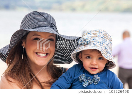Portrait of a young woman with her baby at the beautiful white beach of Lake Tota located in the department of Boyaca at 3,015 meters above sea level in Colombia Portrait of a young woman with her baby at the beautiful white beach of Lake Tota located in the department of Boyaca at 3,015 meters above sea level in Colombia 105226498