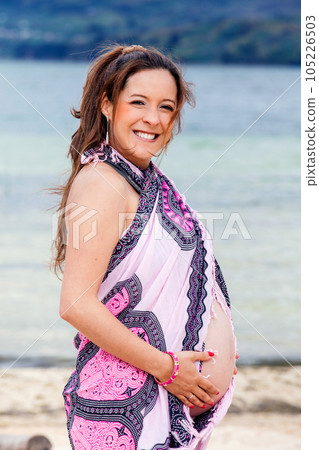 Portrait of a young woman waiting for her baby at the beautiful white beach of Lake Tota located in the department of Boyaca at 3,015 meters above sea level in Colombia Portrait of a young woman waiting for her baby at the beautiful white beach of Lake Tota located in the department of Boyaca at 3,015 meters above sea level in Colombia 105226503