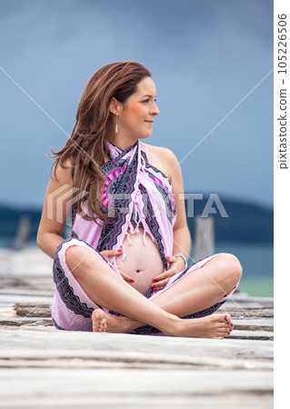 Portrait of a young woman waiting for her baby at the beautiful white beach of Lake Tota located in the department of Boyaca at 3,015 meters above sea level in Colombia Portrait of a young woman waiting for her baby at the beautiful white beach of Lake Tota located in the department of Boyaca at 3,015 meters above sea level in Colombia 105226506
