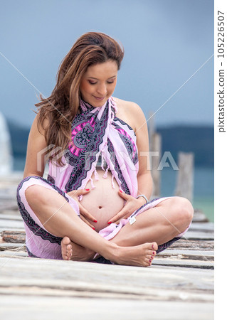 Portrait of a young woman waiting for her baby at the beautiful white beach of Lake Tota located in the department of Boyaca at 3,015 meters above sea level in Colombia 105226507