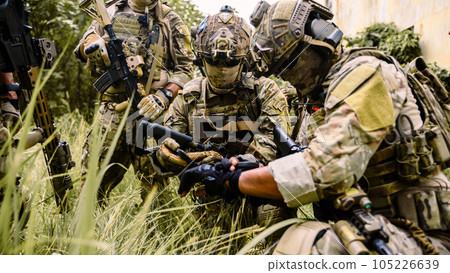 Smart teamwork of soldiers running forward and attacking enemy during military operation, Army soldiers in protective combat uniform, Soldiers with rifle, Soldiers with rifle on world war field Smart teamwork of soldiers running forward and attacking enemy during military operation, Army soldiers in protective combat uniform, Soldiers with rifle, Soldiers with rifle on world war field 105226639
