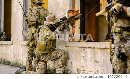 Smart teamwork of soldiers running forward and attacking enemy during military operation, Army soldiers in protective combat uniform, Soldiers with rifle, Soldiers with rifle on world war field Smart teamwork of soldiers running forward and attacking enemy during military operation, Army soldiers in protective combat uniform, Soldiers with rifle, Soldiers with rifle on world war field 105226644