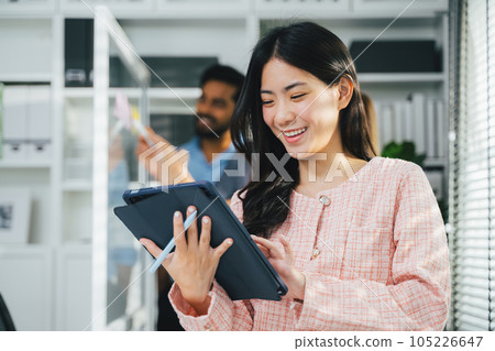 Happy business people working at modern office, Business team meeting and brainstorming at company, Employees using laptop working with business project 105226647