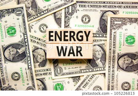 Energy war symbol. Concept words Energy war on beautiful wooden block. Beautiful background from dollar bills. Business and Energy war concept. Copy space. Energy war symbol. Concept words Energy war on beautiful wooden block. Beautiful background from dollar bills. Business and Energy war concept. Copy space. 105226813
