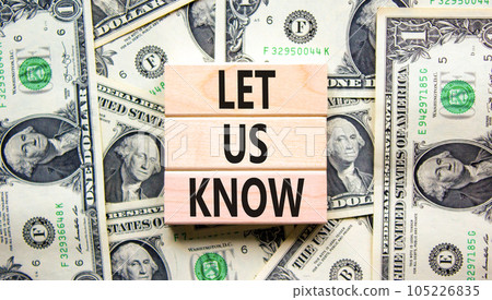 Let us know symbol. Concept words Let us know on wooden blocks on a beautiful background from dollar bills. Business and let us know concept. Copy space. 105226835