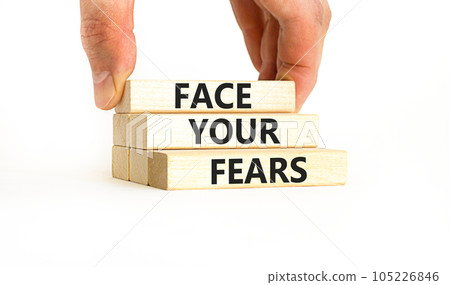 Face your fears and support symbol. Concept words Face your fears on wooden blocks. Businessman hand. Beautiful white table white background. Business and Face your fears quote concept. Copy space. 105226846