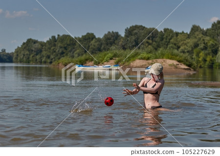 Girl at the beach running playing catching ball Girl at the beach running playing catching ball 105227629