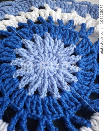 Blue, white round crochet elements and balls of yarn. Crochet texture, place for an inscription, adapted for mobile phone 105228075