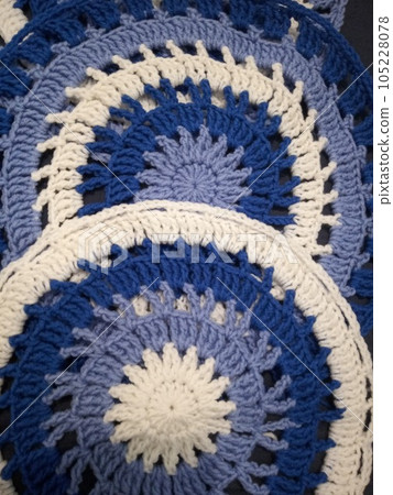 Blue, white round crochet elements and balls of yarn. Crochet texture, place for an inscription, adapted for mobile phone Blue, white round crochet elements and balls of yarn. Crochet texture, place for an inscription, adapted for mobile phone 105228078