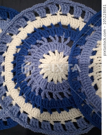 Blue, white round crochet elements and balls of yarn. Crochet texture, place for an inscription, adapted for mobile phone Blue, white round crochet elements and balls of yarn. Crochet texture, place for an inscription, adapted for mobile phone 105228081