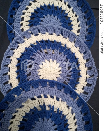 Blue, white round crochet elements and balls of yarn. Crochet texture, place for an inscription, adapted for mobile phone Blue, white round crochet elements and balls of yarn. Crochet texture, place for an inscription, adapted for mobile phone 105228087