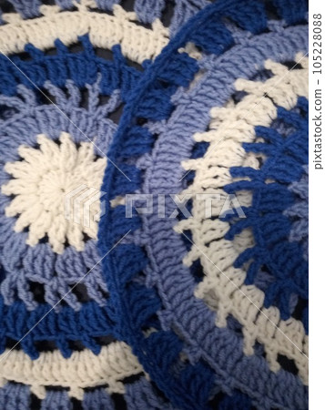 Blue, white round crochet elements and balls of yarn. Crochet texture, place for an inscription, adapted for mobile phone Blue, white round crochet elements and balls of yarn. Crochet texture, place for an inscription, adapted for mobile phone 105228088