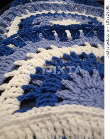 Blue, white round crochet elements and balls of yarn. Crochet texture, place for an inscription, adapted for mobile phone Blue, white round crochet elements and balls of yarn. Crochet texture, place for an inscription, adapted for mobile phone 105228090