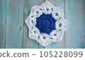 Blue, white crochet elements and orchid. Crochet texture, place for an inscription, adapted for mobile phone 105228099