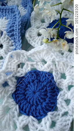 Blue, white crochet elements and orchid. Crochet texture, place for an inscription, adapted for mobile phone 105228100