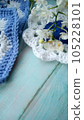 Blue, white crochet elements and orchid. Crochet texture, place for an inscription, adapted for mobile phone 105228101