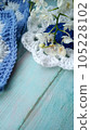 Blue, white crochet elements and orchid. Crochet texture, place for an inscription, adapted for mobile phone 105228102