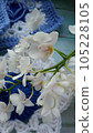 Blue, white crochet elements and orchid. Crochet texture, place for an inscription, adapted for mobile phone 105228105