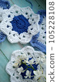 Blue, white crochet elements and orchid. Crochet texture, place for an inscription, adapted for mobile phone 105228108