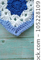 Blue, white crochet elements and orchid. Crochet texture, place for an inscription, adapted for mobile phone 105228109