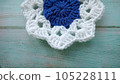 Blue, white crochet elements and orchid. Crochet texture, place for an inscription, adapted for mobile phone 105228111