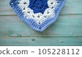 Blue, white crochet elements and orchid. Crochet texture, place for an inscription, adapted for mobile phone 105228112