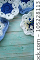 Blue, white crochet elements and orchid. Crochet texture, place for an inscription, adapted for mobile phone 105228113