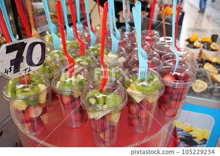 Ripe Red Strawberries in. plastic container selling at shop  105229234