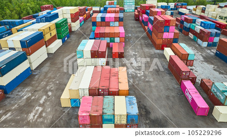 Rows of colorful semi truck trailers in shipping yard, pastel colored shipping containers aerial 105229296