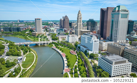 Downtown Columbus Ohio skyscrapers with Scioto River and green promenade and greenway aerial Downtown Columbus Ohio skyscrapers with Scioto River and green promenade and greenway aerial 105229321
