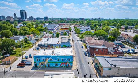 W 4th St and Wells St fox and wolf mural in downtown Fort Wayne with distant skyscrapers 105229336