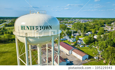 Close up aerial of Huntertown water tower with distant buildings and trees 105229343