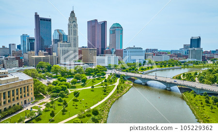 Summer day with green trees and trails aerial of Columbus Ohio downtown skyscrapers 105229362