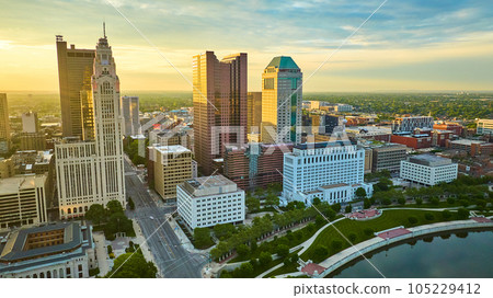 Golden sunlight striking main four Columbus Ohio downtown buildings aerial with river Golden sunlight striking main four Columbus Ohio downtown buildings aerial with river 105229412