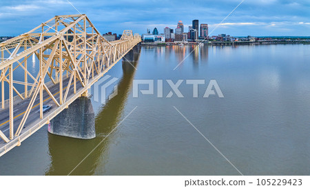 Panorama Ohio River rose gold truss bridge spanning toward illuminated Louisville skyscrapers Panorama Ohio River rose gold truss bridge spanning toward illuminated Louisville skyscrapers 105229423