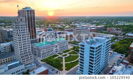 Panorama golden orange sunrise over summertime courthouse in downtown Fort Wayne aerial Panorama golden orange sunrise over summertime courthouse in downtown Fort Wayne aerial 105229540