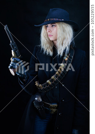 blonde girl wearing black hat with revolver blonde girl wearing black hat with revolver 105229555